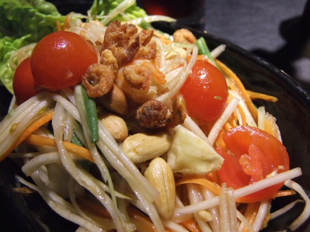 classic spicy papaya salad with cherry tomatoes and roasted nuts at suda