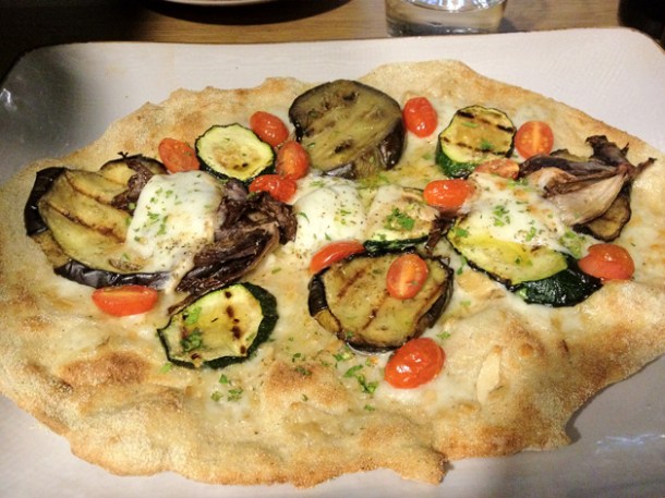 pizza topped with grilled aubergines, zucchini, radicchio, chopped parsley and smoked mozzarella at obika