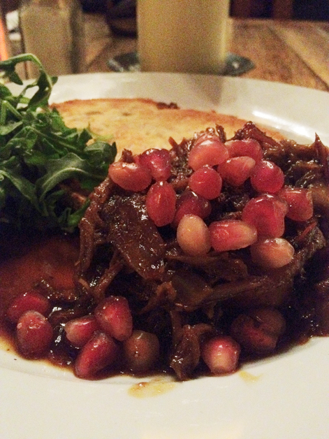lamb shoulder on toast with pomegrante seeds at the old dairy