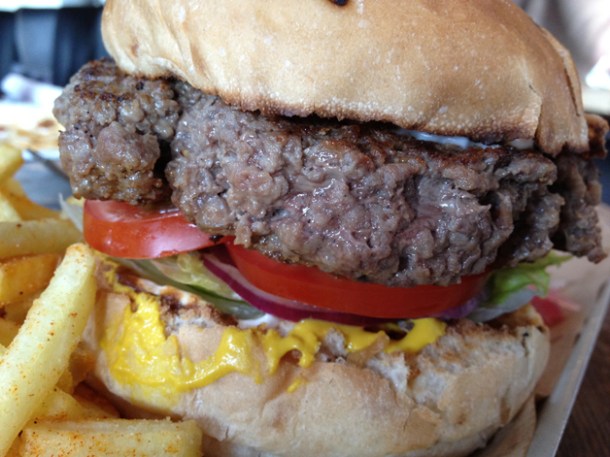 close up of burger at duke's brew and que