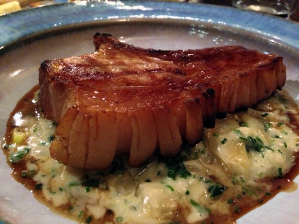 pork chop with beer braised onions at newman street tavern