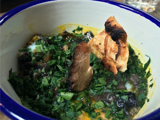 broken eggs with mushrooms, garlic and parsley at barnyard