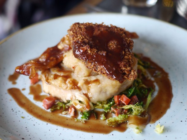 spit roasted pork with chorizo cabbage and apple sauce at le chalet