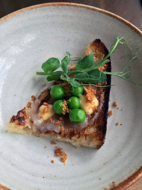 lardo and peas on sourdough at pidgin